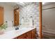 Stylish bathroom with patterned wallpaper and a tub at 3420 S Nucla Way, Aurora, CO 80013