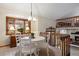 Bright dining area with a white table and chairs, a large window, and access to upper loft at 3420 S Nucla Way, Aurora, CO 80013