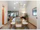 Open concept dining area with glass table and view into living room at 3420 S Nucla Way, Aurora, CO 80013