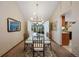 Bright dining room with glass table, bamboo chairs, and access to a sunroom at 3420 S Nucla Way, Aurora, CO 80013