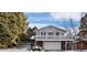 Two-story house with a deck, attached garage, and snowy landscaping at 3420 S Nucla Way, Aurora, CO 80013