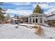 View of house back, deck, and yard in winter at 3420 S Nucla Way, Aurora, CO 80013