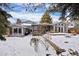 Back of house with large deck and snow covered yard at 3420 S Nucla Way, Aurora, CO 80013