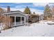 Back of house with large windows and snow covered yard at 3420 S Nucla Way, Aurora, CO 80013