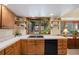 Kitchen boasts wood cabinets, a double sink, and tile countertops at 3420 S Nucla Way, Aurora, CO 80013