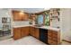 Cozy kitchen featuring wood cabinets, tiled countertops, and stainless steel appliances at 3420 S Nucla Way, Aurora, CO 80013