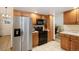 Kitchen with stainless steel refrigerator, wood cabinets, and tile flooring at 3420 S Nucla Way, Aurora, CO 80013