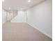 Finished basement with carpeted floors and staircase at 991 S Holly St, Denver, CO 80246