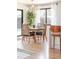 Light-filled dining area with wood table and chairs near sliding glass doors at 991 S Holly St, Denver, CO 80246