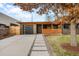 Modern ranch home with attached garage and landscaped front yard at 991 S Holly St, Denver, CO 80246