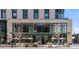 Modern building exterior with restaurant and patio seating at 991 S Holly St, Denver, CO 80246