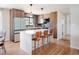 Modern kitchen with white island and wood cabinets at 991 S Holly St, Denver, CO 80246