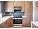 Modern kitchen with dark herringbone tile and wood cabinets at 991 S Holly St, Denver, CO 80246