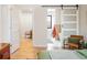 Main bedroom with sliding barn door to en-suite bathroom at 991 S Holly St, Denver, CO 80246