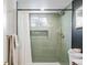 Sage green tiled shower with built-in shelving at 991 S Holly St, Denver, CO 80246