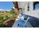 Inviting outdoor porch featuring lounge chairs and views of the lawn at 2705 Fox View Trl, Franktown, CO 80116