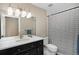 Modern bathroom featuring black vanity, white countertop, and stylish shower curtain at 2705 Fox View Trl, Franktown, CO 80116