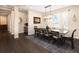 Elegant dining room featuring a wooden table, stylish chandelier, and view to a butler's pantry at 2705 Fox View Trl, Franktown, CO 80116