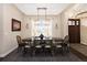 Inviting dining room with a large wooden table, modern lighting, and natural light from the window at 2705 Fox View Trl, Franktown, CO 80116