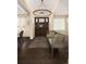 Bright entryway with a striking wooden door, bench seating, modern chandelier, and hardwood floors at 2705 Fox View Trl, Franktown, CO 80116