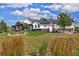 Striking home exterior featuring lush green grass, tasteful landscaping, and architectural details at 2705 Fox View Trl, Franktown, CO 80116