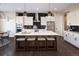 Modern kitchen boasts a large island, stainless steel appliances, and sleek lighting at 2705 Fox View Trl, Franktown, CO 80116