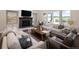 Cozy living room features a stone fireplace, lots of natural light, and comfortable seating at 2705 Fox View Trl, Franktown, CO 80116