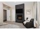 Comfortable main bedroom featuring a stacked stone fireplace and cozy seating area at 2705 Fox View Trl, Franktown, CO 80116