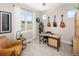 Bright office space with large windows, a modern desk, and guitars displayed on the wall at 2705 Fox View Trl, Franktown, CO 80116