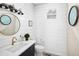 Charming powder room featuring shiplap walls and stylish black and gold fixtures at 2705 Fox View Trl, Franktown, CO 80116