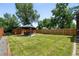Spacious back yard featuring a fenced yard, mature trees, and a gazebo with outdoor seating, perfect for outdoor entertaining at 4604 Routt St, Wheat Ridge, CO 80033