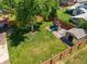 Aerial view of spacious backyard with large tree, swing set, shed, and well-maintained lawn at 4604 Routt St, Wheat Ridge, CO 80033