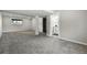 Spacious unfinished basement featuring gray carpet, columns, and a convenient bathroom at 4604 Routt St, Wheat Ridge, CO 80033