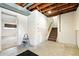 Unfinished basement space with exposed beams and stairs at 4604 Routt St, Wheat Ridge, CO 80033