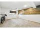 Partially finished basement room with wood accent wall and carpet at 4604 Routt St, Wheat Ridge, CO 80033