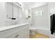 Well-lit bathroom featuring a vanity, shower-tub, and tile flooring at 4604 Routt St, Wheat Ridge, CO 80033