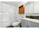 Clean bathroom featuring updated fixtures, white tiled shower and tub, and a modern vanity area at 4604 Routt St, Wheat Ridge, CO 80033