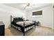 Simple bedroom with black metal frame bed, neutral carpet, and one window at 4604 Routt St, Wheat Ridge, CO 80033