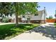 Welcoming two-story home featuring a lush green lawn and a long driveway at 4604 Routt St, Wheat Ridge, CO 80033