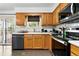 Functional kitchen with wooden cabinets, white countertops, and a full suite of appliances at 4604 Routt St, Wheat Ridge, CO 80033