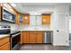 Modern kitchen featuring stainless steel appliances, wood cabinets, and white countertops at 4604 Routt St, Wheat Ridge, CO 80033