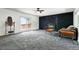Inviting living room with a cozy fireplace, new carpet, and sliding glass doors leading to the outdoor living space at 4604 Routt St, Wheat Ridge, CO 80033