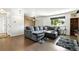 Cozy living room with wood floors, a large window, and a comfortable gray sectional sofa at 4604 Routt St, Wheat Ridge, CO 80033