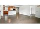 Bright living area featuring hardwood floors connecting to the kitchen with breakfast bar at 4604 Routt St, Wheat Ridge, CO 80033
