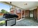 Covered patio with grill, brick accents, and access to backyard and upper deck at 4604 Routt St, Wheat Ridge, CO 80033