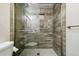 Beautifully tiled walk-in shower with glass door, rainfall shower head, and built-in niche at 4604 Routt St, Wheat Ridge, CO 80033
