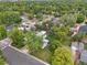 Expansive aerial view showcasing a neighborhood with lush green trees and well-maintained homes at 3218 S Lafayette St, Englewood, CO 80113