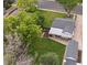 Aerial view of a home showcasing a big backyard, a covered patio, a lush lawn, mature trees, and a storage shed at 3218 S Lafayette St, Englewood, CO 80113