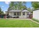 Well-manicured backyard with a covered patio and convenient access, perfect for outdoor enjoyment and relaxation at 3218 S Lafayette St, Englewood, CO 80113