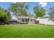 Lush backyard featuring a well-maintained lawn, shaded patio, and a fenced perimeter, offering privacy at 3218 S Lafayette St, Englewood, CO 80113